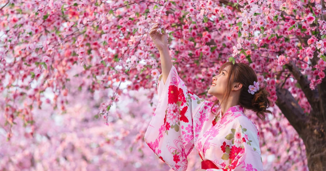 A lady in a kimono stands under a sakura tree, admiring the cherry blossoms. Not because they are beautiful, but because they represent making loads of cold, hard cash for her e-commerce store.