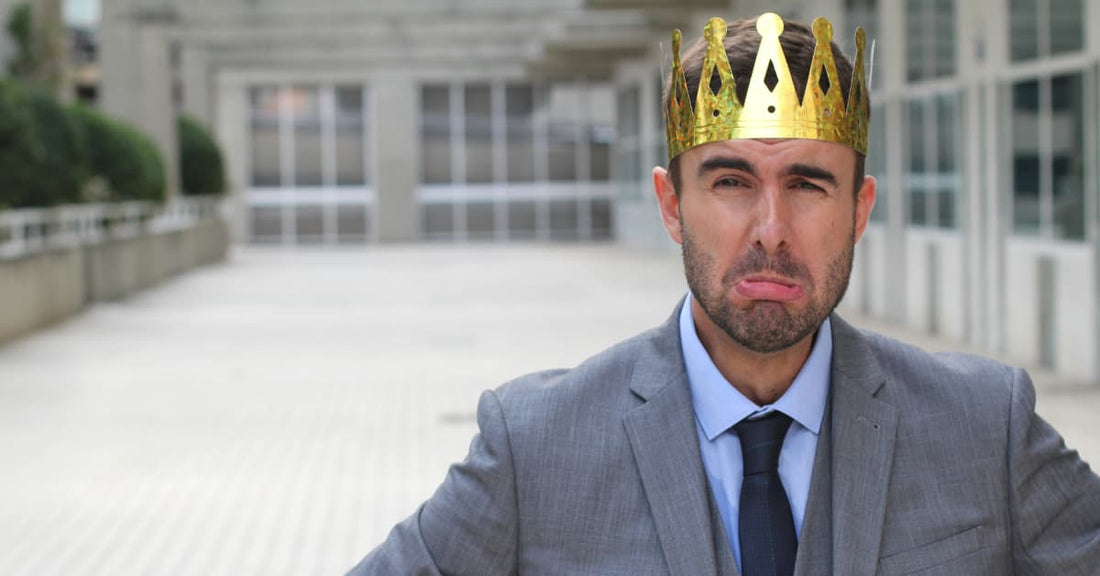 A man in a golden crown and business suit looks upset. This is because he can't import his china-made games in America anymore.