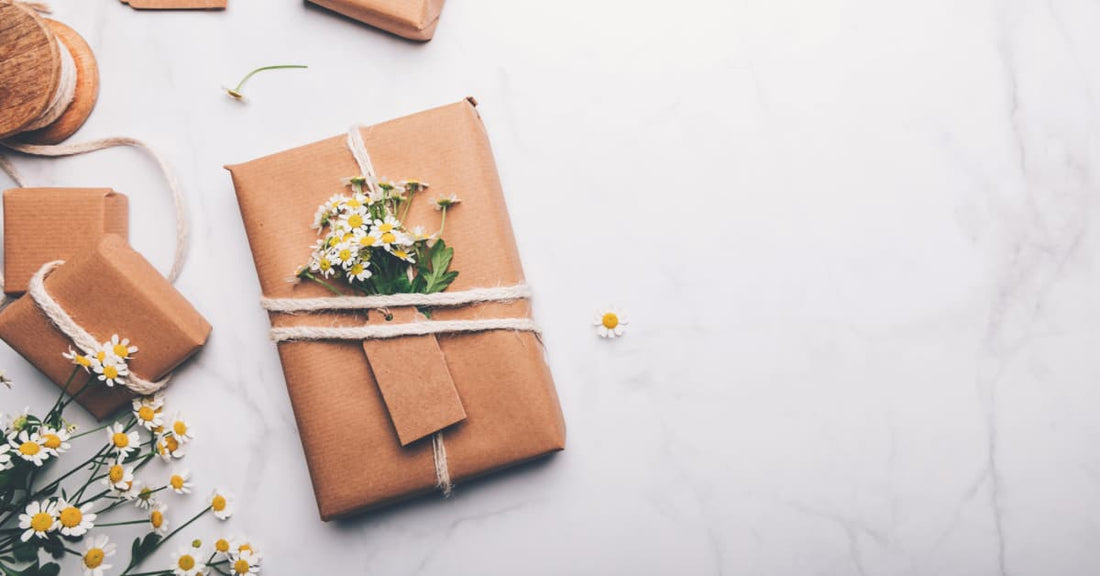 This is a picture of an arrangement of small white/yellow flowers that have been artistically strapped to a paper-wrapped box. It's probably a metaphor for the death of capitalism or something.