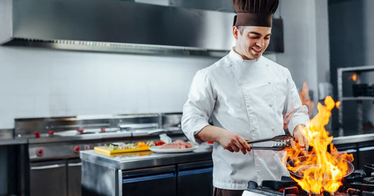 A michelin-star cook smiles as his food literally burns in a pan. Or perhaps he's burning his wallet, because he didn't read this helpful blog post.